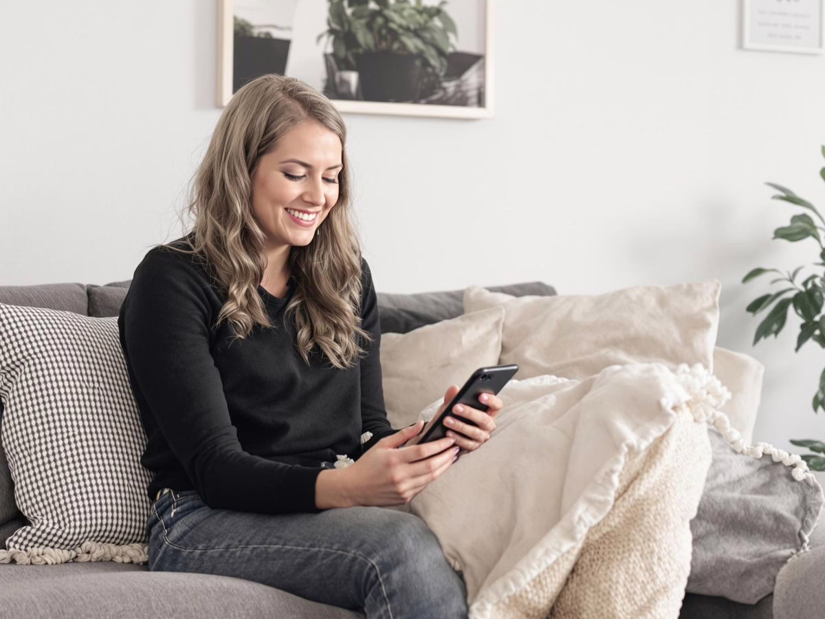 Person budgeting in a cozy, minimalist living space.